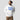 Model wearing the white In ADA We Trust Hoodie, showing the relaxed unisex fit